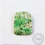 A carved jade plaque within brooch setting,