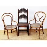 A carved oak Derbyshire type chair, with two French cafe chairs,