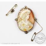A 9ct gold mounted cameo brooch depicting a female profile wearing a fruit bonnet, 5.