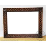 A 1920's carved oak mirror with bevelled plate, 88.
