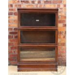 A Globe Wernicke oak three section bookcase, with label to one of the sections, on plinth base,