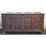 A late 17th century oak coffer, with panelled top and front and later carved detailing,