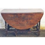 An 18th century oval oak gate leg table, on barley twist and block legs,