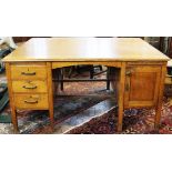 A golden oak partners desk, each side with three drawers and a cupboard door,