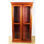 An Edwardian mahogany bookcase, with two glazed doors enclosing adjustable shelves, on plinth base,