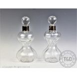 A near pair of silver mounted decanters and stoppers, London 1908, 25.