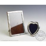 A heart shaped photograph frame, with white metal mount stamped 'Sterling', engraved bow detail,