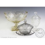 A 19th century cut glass cup and cover, 20cm high, with a large pressed glass centrepiece,