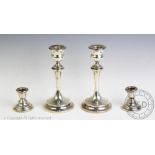 A pair of George V silver candlesticks 'S J & S Ltd', Chester 1927, each of plain baluster form,