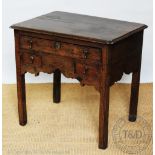 An 18th century and later oak low boy with three drawers,