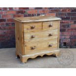 A pine chest of two short and two long drawers on bracket feet,