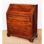 An early 20th century oak bureau, with fall over four long drawers, on bracket feet,