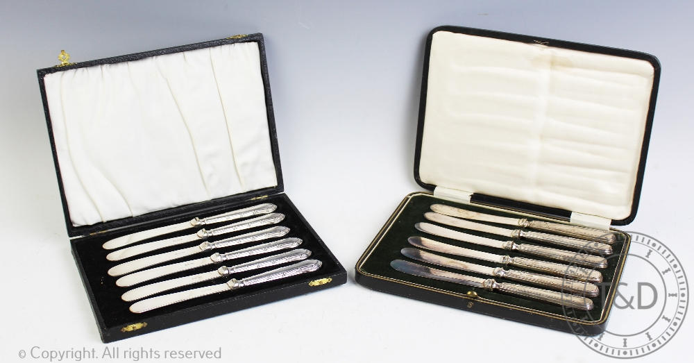 Two cased sets of six silver handled butter knives,