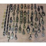 A selection of 19th century and later horse brasses, mostly on leather backing sections,