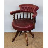An Edwardian walnut swivel desk chair, with button back,