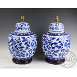 A pair of modern blue and white table lamps, modelled as ginger jars and covers,