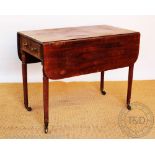 An early 19th century mahogany Pembroke table, with drawer, on fluted and turned tapered legs,