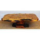 A French burr oak coffee table, with naturalistic shaped top,