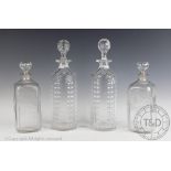 A pair of Victorian cylindrical decanters and stoppers, each with oval cut faceted detail,