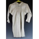 A hand woven linen smock, with floral embroidered and smocked detail to the front and back,