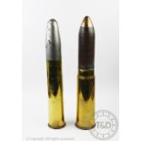 Two military shell cases, one designed as a money box,