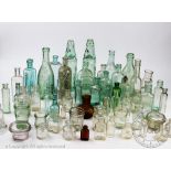 A collection of 19th century and later glass bottles and ceramic jars,