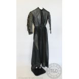 A black half mourning dress, circa 1860's, the dress constructed from a coarse muslin type fabric,