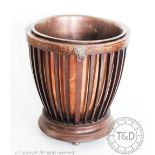 An Edwardian mahogany jardiniere, with slatted sides and lion mask handles, copper liner, 26.
