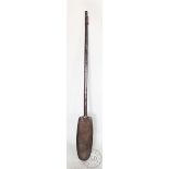 A long wooden paddle / oar, possibly tribal, with tapered shaft and oval shaped paddle,