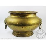 A large brass jardiniere, with twin lion mask handles,