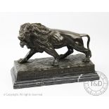 A modern bronze model of a lion, with Greek key detailing, on marble base,