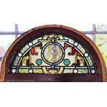A pair of 19th century stained glass panels, of Aesthetic type, of arched shape,