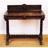 A Victorian carved oak hall table, with raised back, on spiral turned end supports,