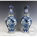 A pair of late 19th/early 20th century Delft vases and covers,