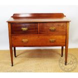 An Edwardian mahogany chest, with two short and one long drawer, on tapered legs,