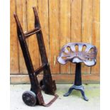 A cast metal implement seat, on associated stand, 53.