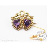 A Victorian amethyst and seed pearl set double heart brooch,