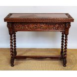 A late Victorian carved light oak folding tea table,