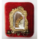A Victorian brass girandole, of Neo-Rococo design, with bevelled mirror plate,