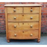 A Victorian pine bow front chest, of two short and three long crawlers, on turned feet,