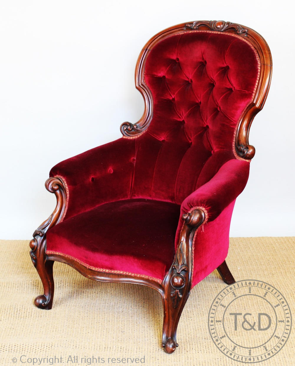 A Victorian carved mahogany salon chair, with button back upholstery,