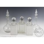 A set of three Edwardian cut glass decanters and stoppers, of cube form, 24.