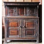 A late 17th / early 18th century oak court cupboard, Westmoreland type, the frieze carved 'TO, MR,