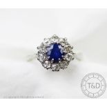 An untested sapphire and diamond circular cluster ring,