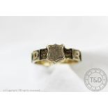 A Victorian REGARD ring, the band inset with letter panels spelling regard and woven hair,