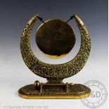 A Indian brass dinner gong, with cast foliate detailing,