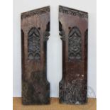 A pair of Victorian carved oak pew ends, decorated with armorial crests,