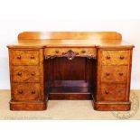 A Victorian walnut and burr walnut desk / dressing table, with seven drawers, on plinth base,