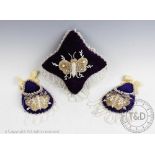 A royal purple pin cushion, with beaded fringing and beaded butterfly design to the top,