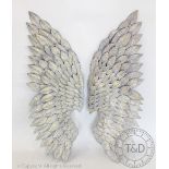 A pair of modern grey and gilt metal angel wings,